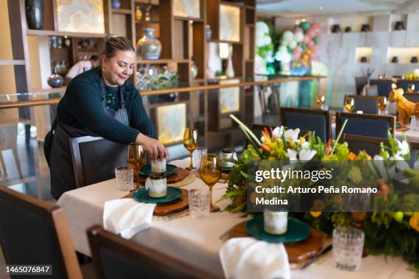 portrait of event planner finishing the last details of the set-up. - event planning stock pictures, royalty-free photos & images