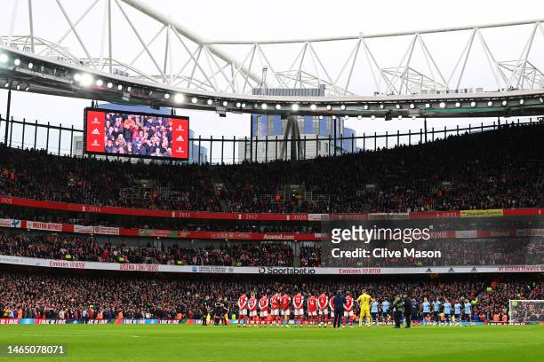 Players, officials and fans observe a minute of silence for the victims of the earthquake in Turkey in Syria prior to the Premier League match...