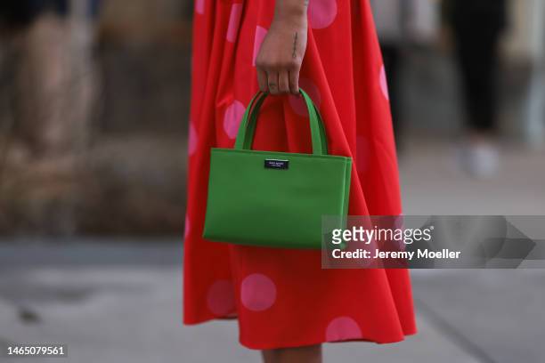 Olivia Joan seen wearing Kate Spade red long skirt with pink polka dot pattern, Kate Spate green leather bag before the Kate Spade presentation on...