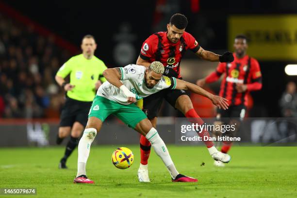 Joelinton of Newcastle United is challenged by Dominic Solanke of AFC Bournemouth during the Premier League match between AFC Bournemouth and...