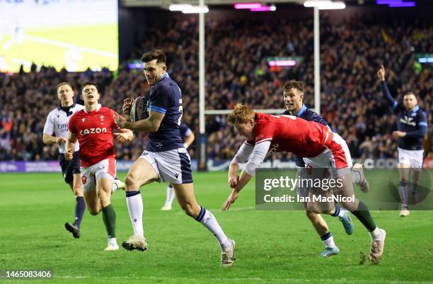 Blair Kinghorn of Scotland breaks with the ball on his way to scoring his team's fourth try during the Six Nations Rugby match between Scotland and...