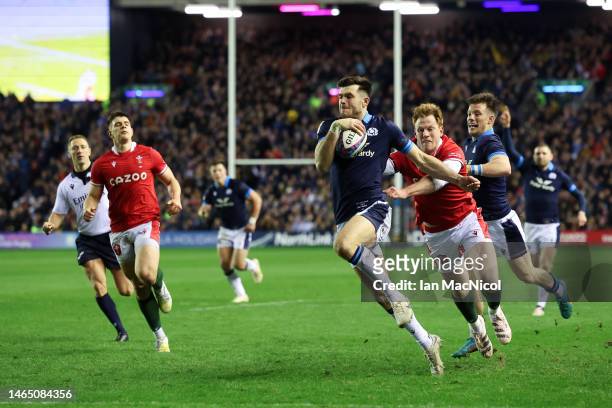 Blair Kinghorn of Scotland breaks with the ball on his way to scoring his team's fourth try during the Six Nations Rugby match between Scotland and...