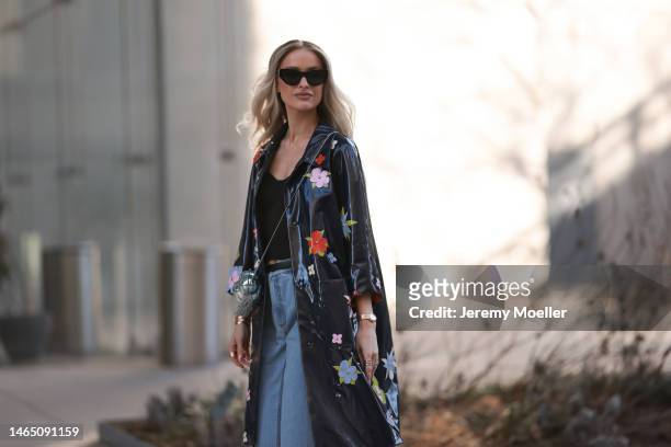 Victoria Magrath seen wearing Saint Laurent black sunglasses, black off-shoulder top, black shiny leather small belt, blue faded denim large...