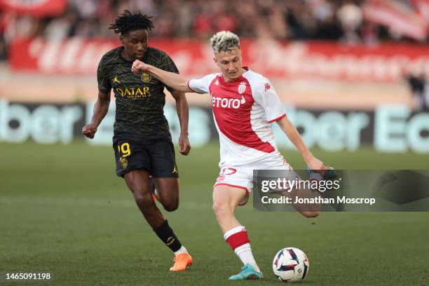 Aleksandr Golovin of AS Monaco is pursued by Timothee Pembele of PSG during the Ligue 1 match between AS Monaco and Paris Saint-Germain at Stade...