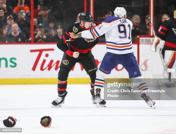 Brady Tkachuk of the Ottawa Senators and Evander Kane of the Edmonton Oilers fight during the second period at Canadian Tire Centre on February 11,...