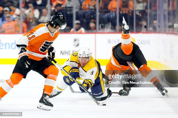 Jeremy Lauzon of the Nashville Predators passes the puck past Nicolas Deslauriers of the Philadelphia Flyers during the second period at Wells Fargo...