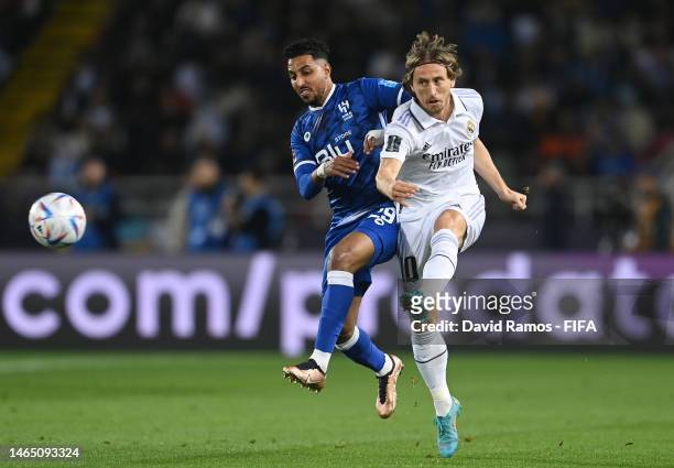 Luka Modric of Real Madrid battles for possession with Salem Aldawsari of Al Hihal during the FIFA Club World Cup Morocco 2022 Final match between...