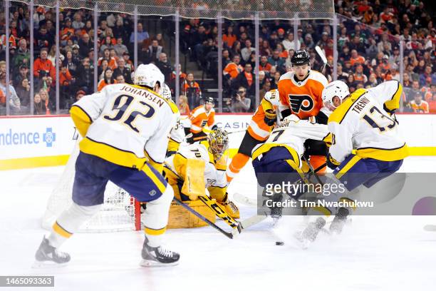 Juuse Saros and Yakov Trenin of the Nashville Predators block a shot during the second period against the Philadelphia Flyers at Wells Fargo Center...