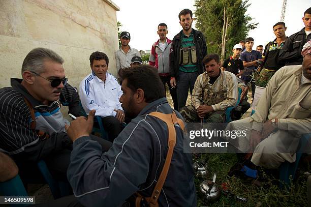 Free Syrian Army battalion commander Colonel Jamil Radoun speaks with his men in Hama Province, Syria, May 24, 2012. Col. Radoon also presides over...