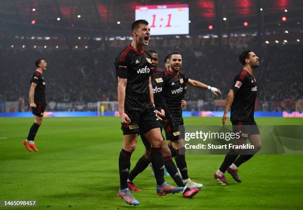 Robin Knoche of 1.FC Union Berlin celebrates with team mates after scoring their sides second goal from the penalty spot during the Bundesliga match...