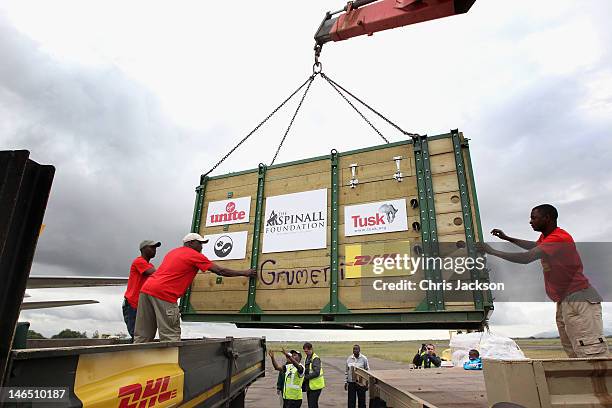 Rhinos are carried on a crane off a specially enlisted DHL Boeing 757 at Kilimanjaro International Airport on June 17, 2012 in Manston, England. The...