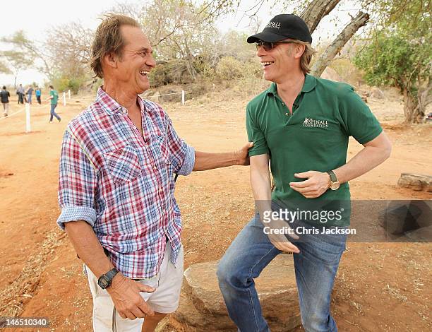 Founder of Mkomazi National Park Tony Fitzjohn and Damien Aspinall smile after the successful translocation of three black rhino from England to...