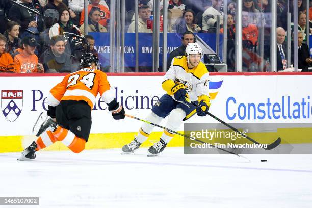 Nick Seeler of the Philadelphia Flyers and Mark Jankowski of the Nashville Predators challenge for the puck during the second period at Wells Fargo...