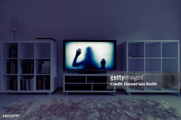 silhouette of girl on television - spooky stock pictures, royalty-free photos & images