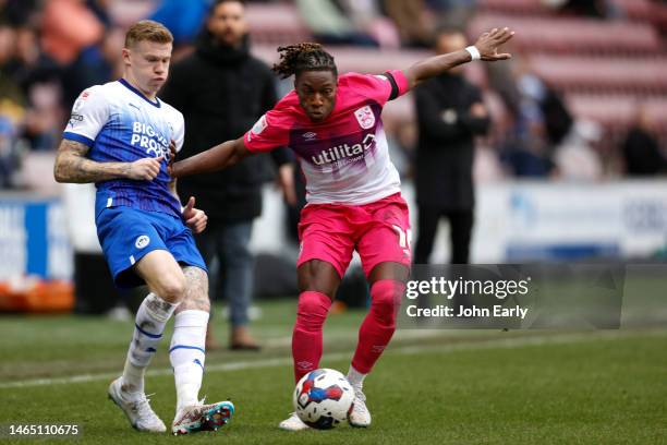 Joseph Hungbo of Huddersfield Town challenges James McClean of Wigan Athletic during the Sky Bet Championship between Wigan Athletic and Huddersfield...