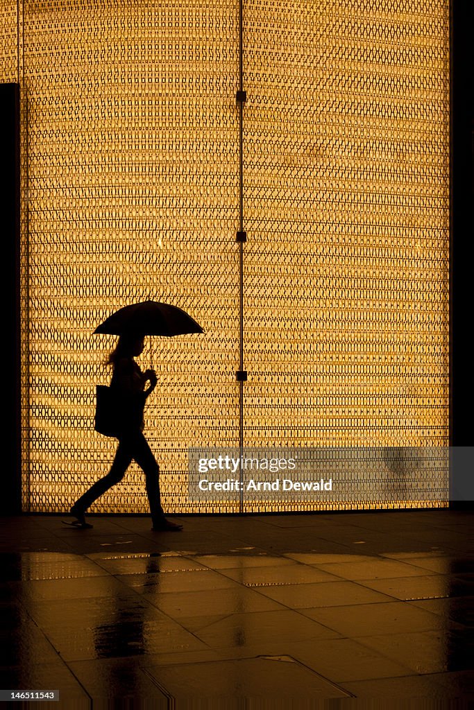 Woman walking with umbrella