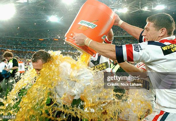 Ricky Stuart, coach of the Roosters is drenched in Gatorade by Bryan Fletcher during the 2002 NRL Grand Final played between the Sydney Roosters and...