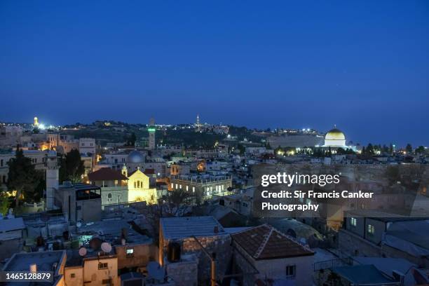 jerusalem old city skyline illuminated at dusk with temple mount, golden dome of the rock, tower of david and church of the holy sepulchre in israel, middle east - jerusalem city stock pictures, royalty-free photos & images