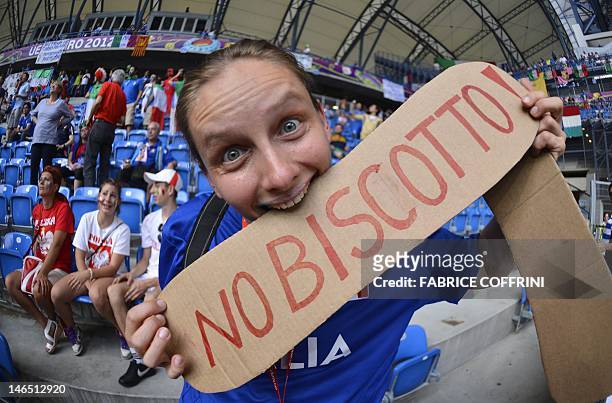 An Italian fan shows bites a placard reading "No Biscotto" before the Euro 2012 football championships match Italy vs Republic of Ireland on June 18,...