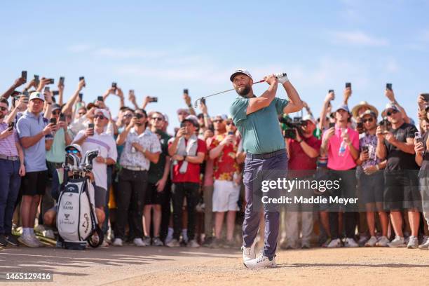 Jon Rahm of Spain plays a second shot on the sixth hole as fans look on during the third round of the WM Phoenix Open at TPC Scottsdale on February...