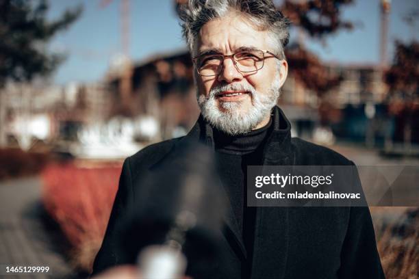 reporter on city street during live broadcast - reportage stock pictures, royalty-free photos & images