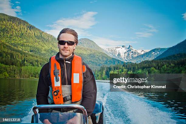 man driving boat - steering boat stock pictures, royalty-free photos & images