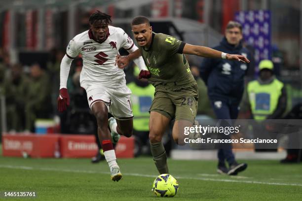 Wilfried Singo of Torino FC and Malick Thiaw of AC Milan battle for the ball during the Serie A match between AC Milan and Torino FC at Stadio...