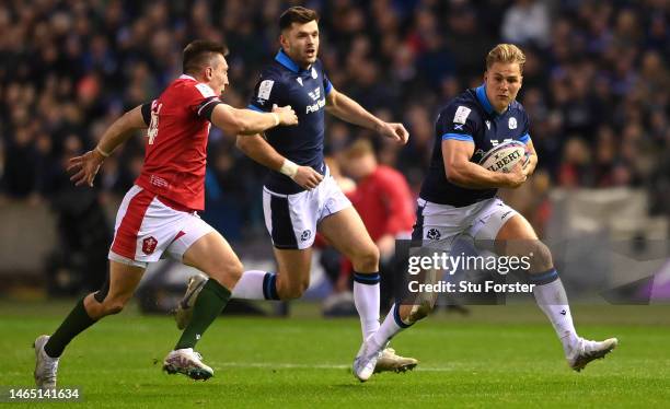 Scotland wing Duhan van der Merwe races past Wales wing Josh Adams during the Six Nations Rugby match between Scotland and Wales at Murrayfield...