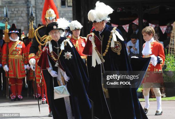 Britain's Queen Elizabeth II and Prince Philip, Duke of Edinburgh, take part in the procession to St George's Chapel for the annual service of the...