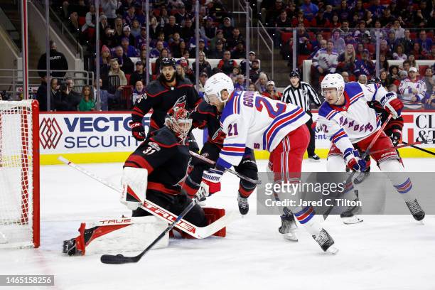 Frederik Andersen of the Carolina Hurricanes makes a save against Barclay Goodrow of the New York Rangers during the first period of the game at PNC...
