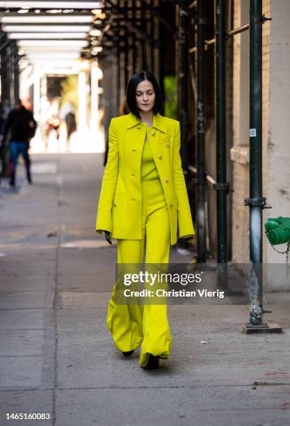 Leigh Lezark wears yellow button up jacket, wide leg pants, shirt outside Proenza Schouler during New York Fashion Week on February 11, 2023 in New...