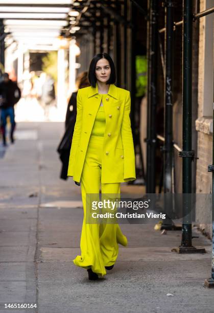 Leigh Lezark wears yellow button up jacket, wide leg pants, shirt outside Proenza Schouler during New York Fashion Week on February 11, 2023 in New...