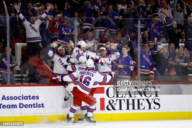 Artemi Panarin of the New York Rangers celebrates with his teammates following his hat trick goal during the third period of the game against the...