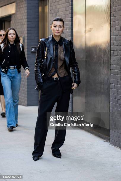 Amalie Gassmann wears black leather jacket, see trough laced top pants, bag outside Proenza Schouler during New York Fashion Week on February 11,...