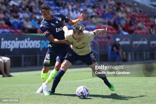 Jason Hoffman of the Jets and Nishan Velupillay of Victory compete for the ball with during the round 16 A-League Men's match between Newcastle Jets...