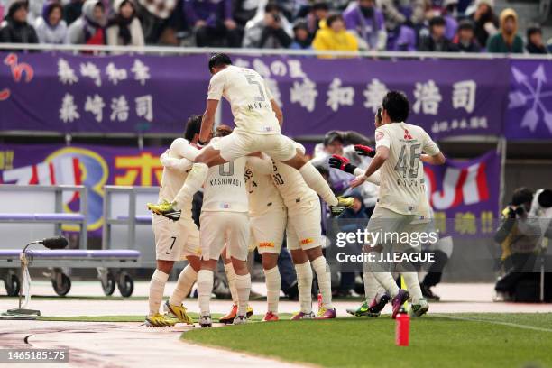 Yosuke Kashiwagi of Sanfrecce Hiroshima celebrates with teammates after scoring the team's first goal during the J.League J1 match between Sanfrecce...