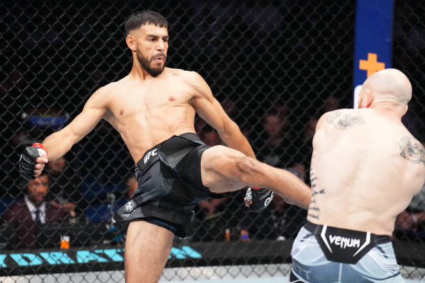 Yair Rodriguez of Mexico kicks Josh Emmett in the UFC interim featherweight championship fight during the UFC 284 event at RAC Arena on February 12,...
