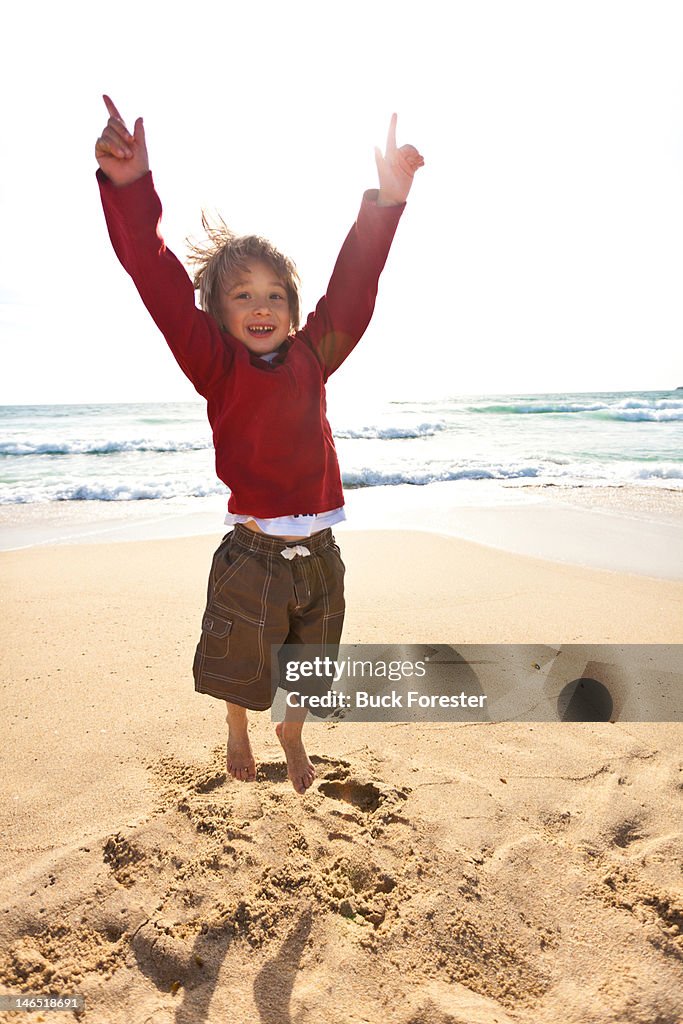 Boy jumping at beach