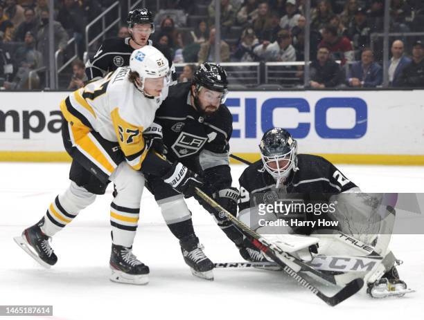 Pheonix Copley of the Los Angeles Kings makes a save on Rickard Rakell of the Pittsburgh Penguins as Drew Doughty attempts to clear the rebound...