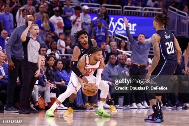 Jalen Brunson of the New York Knicks dribbles the ball as Gary Harris of the Orlando Magic defends during the fourth quarter at Amway Center on...