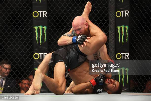 Josh Emmett of the United States and Yair Rodriguez of Mexico ba in the UFC interim featherweight championship fight during UFC 284 at RAC Arena on...