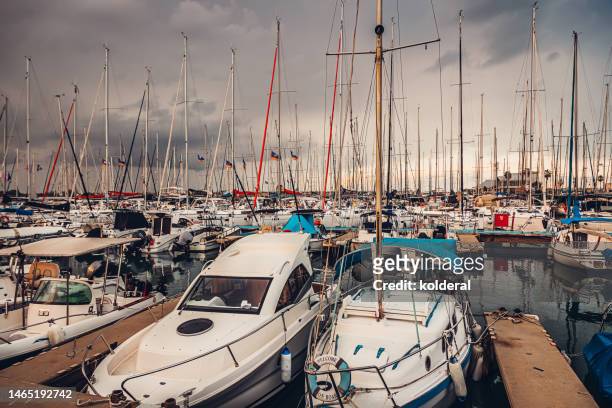 yachts moored in mediterranean marina, during rainy stormy weather - herzliya marina stock-fotos und bilder