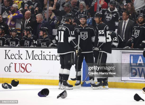 Adrian Kempe of the Los Angeles Kings celebrates his hat trick goal with Anze Kopitar and Quinton Byfield, his third goal of the period to take a 5-0...