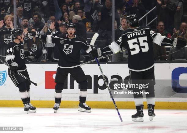 Adrian Kempe of the Los Angeles Kings celebrates his second goal of the game with Mikey Anderson and Quinton Byfield, to take a 4-0 lead over the...