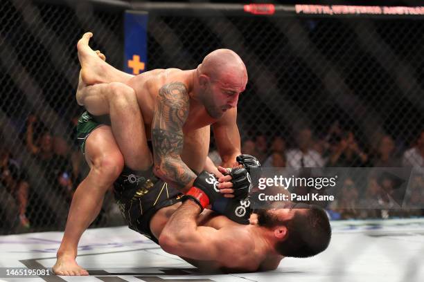 Alex Volkanovski of Australia battles Islam Makhachev of Russia in the UFC lightweight championship fight during UFC 284 at RAC Arena on February 12,...