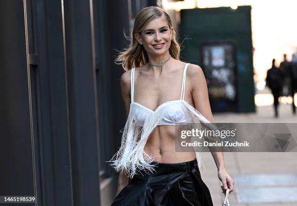 Xenia Adonts is seen wearing a white fringe bralette and silver chain outside the Proenza Schouler show during New York Fashion Week F/W 2023 on...