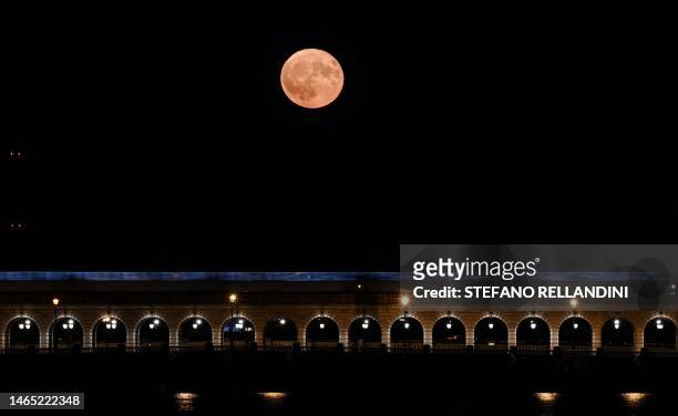 This photograph taken in Paris on July 3, 2023 shows the July's supermoon, known as the Buck Moon, with the 'Pont de Bercy' in the foreground.