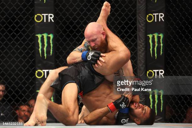 Yair Rodriguez of Mexico and Josh Emmett of the United States battle in the UFC interim featherweight championship fight during UFC 284 at RAC Arena...