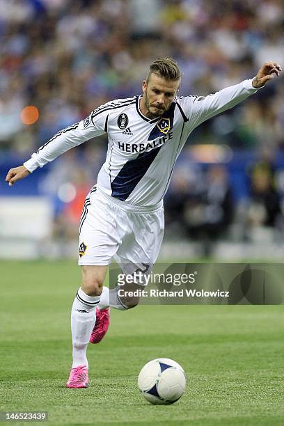 David Beckham of the Los Angeles Galaxy kicks the ball the during a free kick to score during the MLS match against the Montreal Impact at the...