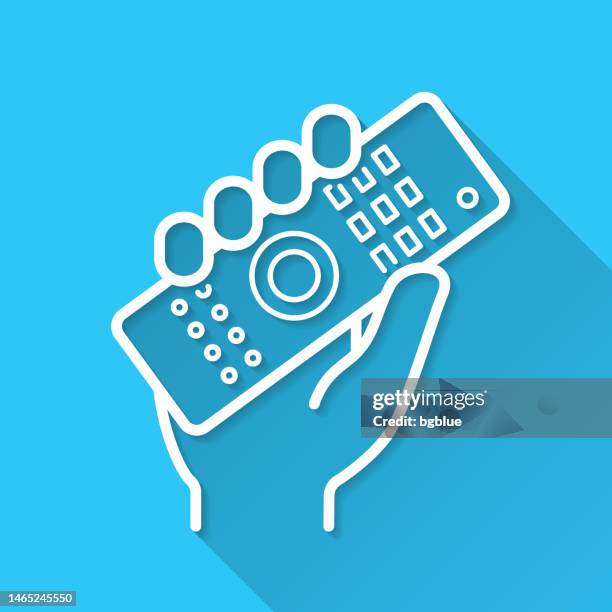 hand holding up remote control. icon on blue background - flat design with long shadow - switch on button stock illustrations